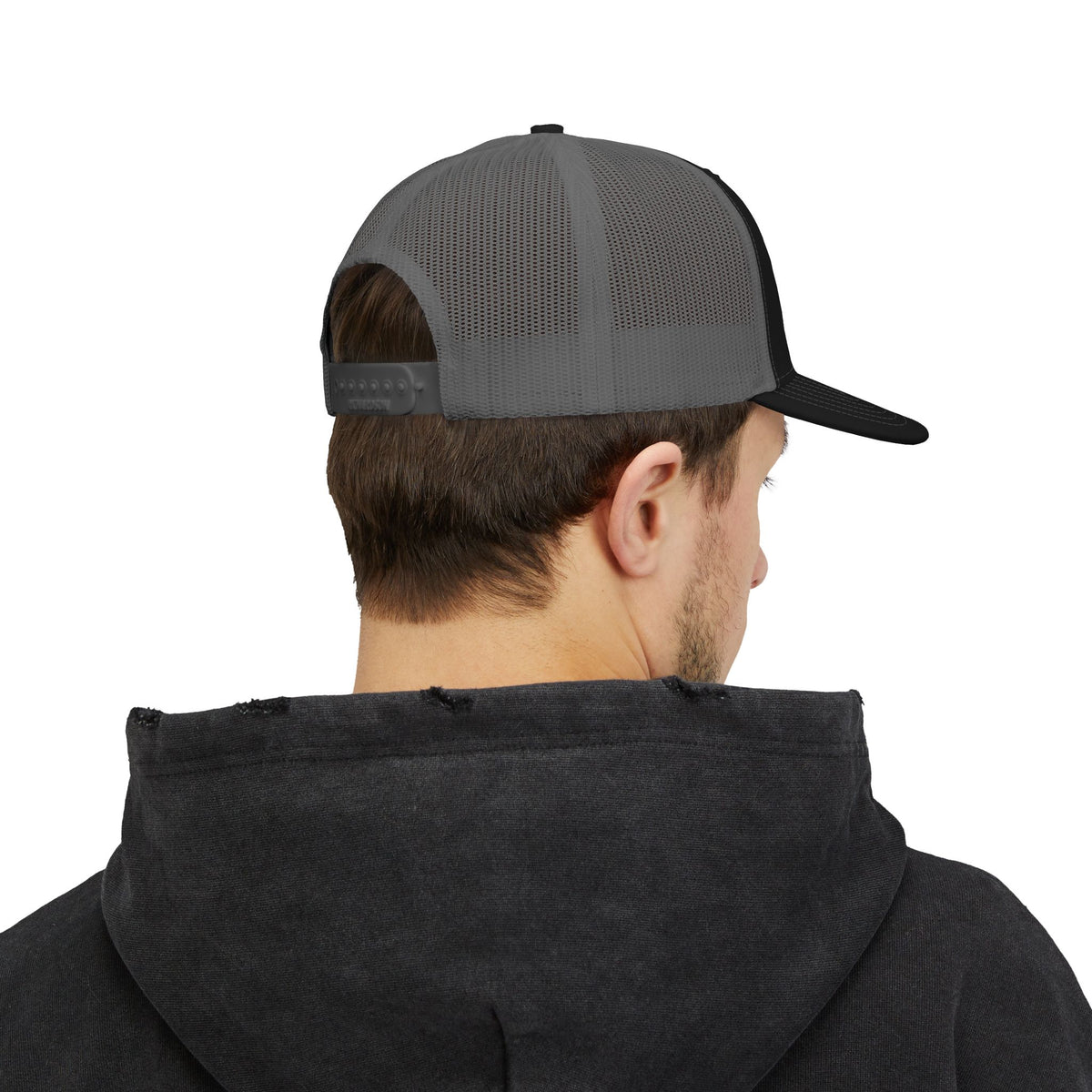 Person wearing a black hoodie and gray and black cap on a white background