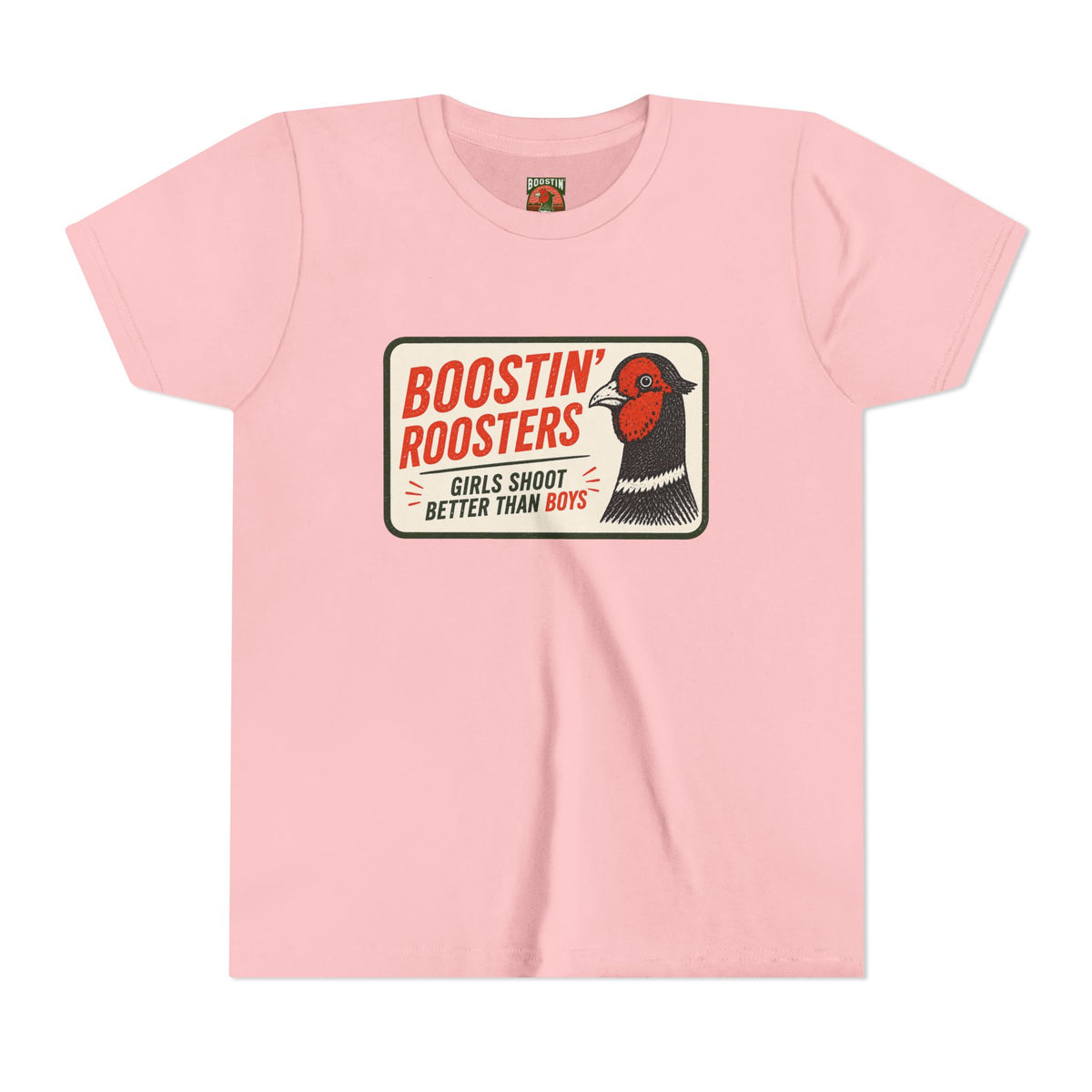 A light pink short-sleeve t-shirt with a vintage-style graphic on the chest. The graphic features a white rounded rectangle with the text 'BOOSTIN' ROOSTERS' in red, 'GIRLS SHOOT BETTER THAN BOYS' in black, and an illustration of a pheasant with a red face and black-and-white body.